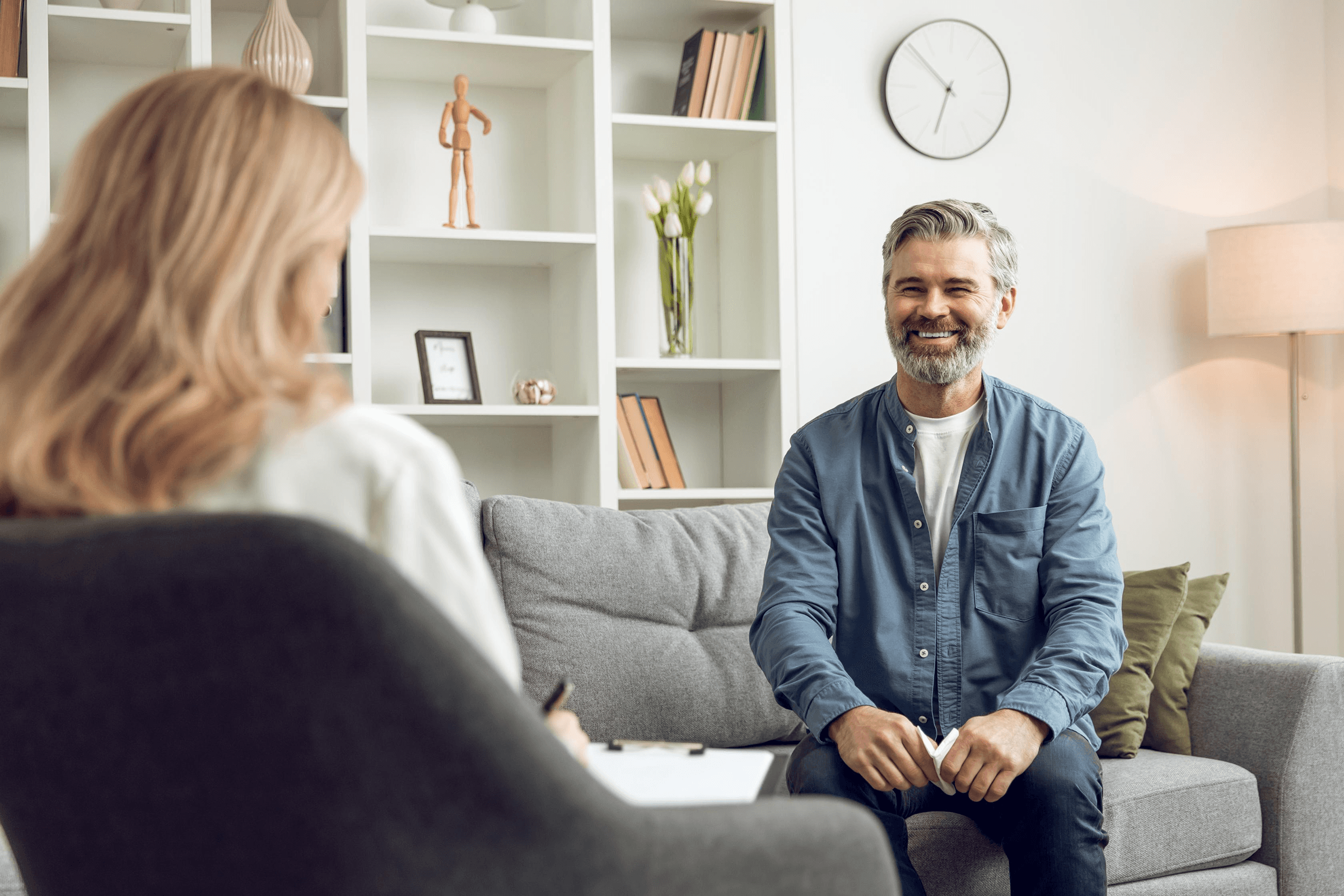 Man smiling during a counseling session.