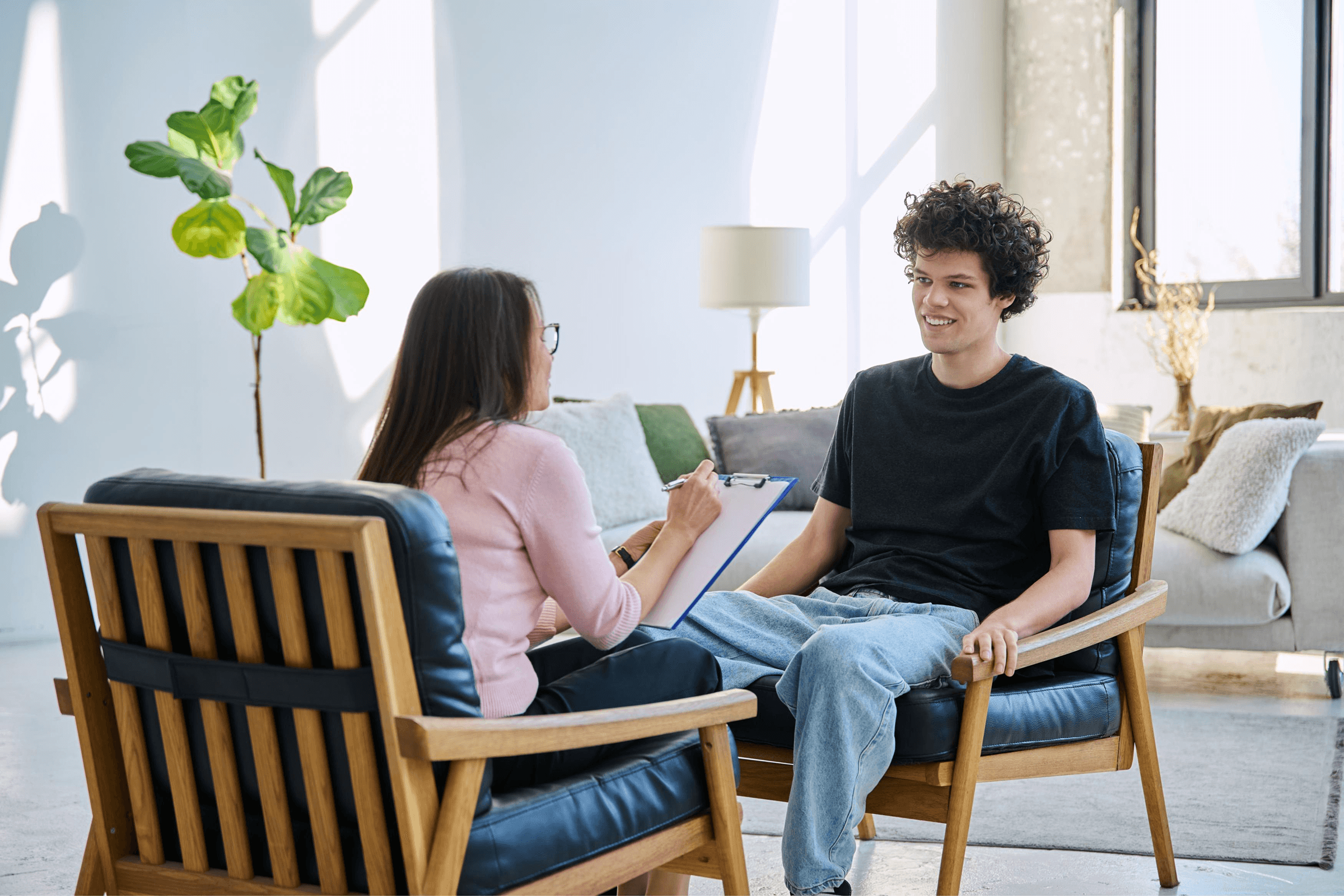 Therapist and client talking in cozy office.